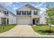 Charming two-story home with a two-car garage, well-manicured lawn and neutral color palette at 4009 Stoneygreen Ln, Charlotte, NC 28215
