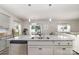 Kitchen island with granite countertop, double sink, and stainless steel dishwasher at 4009 Stoneygreen Ln, Charlotte, NC 28215