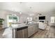 Open kitchen and living room layout with hardwood floors and stainless steel appliances at 4009 Stoneygreen Ln, Charlotte, NC 28215