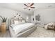 Bedroom features a ceiling fan, neutral tones, and decorative wall mirror at 4009 Stoneygreen Ln, Charlotte, NC 28215