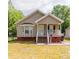 Charming one-story home features a welcoming front porch and manicured lawn at 420 Baker Street Ext, Rock Hill, SC 29730