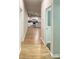 Bright hallway leads to kitchen featuring white cabinets and modern appliances at 420 Baker Street Ext, Rock Hill, SC 29730