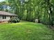 Expansive backyard featuring a shed, lush lawn, and mature trees at 4225 Stewart Rd, Claremont, NC 28610