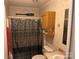 Full bathroom with a shower and tub combination, wooden cabinets, and 'Welcome to the Lake' decor at 4225 Stewart Rd, Claremont, NC 28610