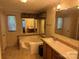 An oversized tub, ample lighting, and large mirrors provide a luxurious feel in this main bathroom at 4225 Stewart Rd, Claremont, NC 28610