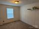 Bedroom with neutral carpet, light walls, and a window with a view of the side yard at 4225 Stewart Rd, Claremont, NC 28610