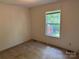 Bedroom with neutral carpet, light walls, and a window with a view of the backyard at 4225 Stewart Rd, Claremont, NC 28610