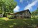 Cozy home exterior featuring a quaint deck, siding, and an expansive lawn at 4225 Stewart Rd, Claremont, NC 28610