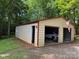 Garage featuring metal construction, parked car, and plenty of storage space at 4225 Stewart Rd, Claremont, NC 28610