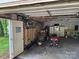 The garage features an unfinished interior with a concrete floor, ample storage and lawn equipment at 4225 Stewart Rd, Claremont, NC 28610