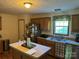 Well-lit kitchen with an island, wooden cabinets, stainless steel appliances, and a window with a backyard view at 4225 Stewart Rd, Claremont, NC 28610