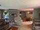 Spacious living room featuring comfortable seating, carpet and wood flooring, with views into other living spaces at 4225 Stewart Rd, Claremont, NC 28610