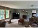 A cozy living room with neutral tones, carpet flooring, comfortable seating and a large window at 4225 Stewart Rd, Claremont, NC 28610