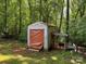 Exterior of a shed outbuilding with a large door and lean-to, surrounded by trees at 4225 Stewart Rd, Claremont, NC 28610