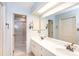 Well-lit bathroom with double sinks, a large mirror, and a glass-enclosed shower showcasing clean design at 4234 Woodglen Ln, Charlotte, NC 28226