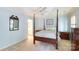 Charming bedroom with a four-poster bed, soft carpet, and a glimpse into an adjoining bathroom at 4234 Woodglen Ln, Charlotte, NC 28226
