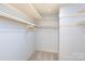 Walk-in closet with shelving and carpeted floor offers organized storage and convenience at 4234 Woodglen Ln, Charlotte, NC 28226