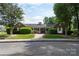 Community clubhouse featuring a brick exterior, well-manicured lawn, and welcoming entrance at 4234 Woodglen Ln, Charlotte, NC 28226