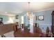 Comfortable dining area featuring an elegant chandelier and access to an inviting living room at 4234 Woodglen Ln, Charlotte, NC 28226