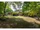Traditional-style home with mature trees and manicured front yard at 4234 Woodglen Ln, Charlotte, NC 28226