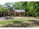 Charming single Gathering home boasts a brick facade, mature trees, and well-manicured lawn at 4234 Woodglen Ln, Charlotte, NC 28226