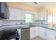 Well-lit kitchen with stainless steel appliances, granite countertops, and white cabinetry at 4234 Woodglen Ln, Charlotte, NC 28226