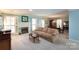 Open-concept living room with fireplace, large windows, and adjacent dining area at 4234 Woodglen Ln, Charlotte, NC 28226