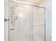 Close-up of a shower with patterned glass doors and chrome fixtures, offering privacy and modern appeal at 4234 Woodglen Ln, Charlotte, NC 28226