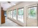 Cozy sunroom with natural light streaming through multiple windows, overlooking a green yard at 4234 Woodglen Ln, Charlotte, NC 28226