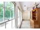 Bright sunroom with many windows, neutral walls, and views of the green backyard at 4234 Woodglen Ln, Charlotte, NC 28226