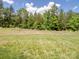 Expansive backyard with lush green grass, ready for outdoor activities and enjoyment at 4316 Falls Lake Sw Dr, Concord, NC 28025