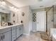 Bright bathroom featuring double sinks, and a glass door shower, providing a spa-like experience at 4316 Falls Lake Sw Dr, Concord, NC 28025
