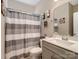 Cozy bathroom with vanity and shower with striped curtain at 4316 Falls Lake Sw Dr, Concord, NC 28025