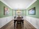 Formal dining room with bay window, chandelier, and wainscoting at 4316 Falls Lake Sw Dr, Concord, NC 28025