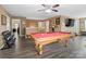 Spacious game room with a pool table, wooden floors, and plenty of space for entertaining guests at 4316 Falls Lake Sw Dr, Concord, NC 28025