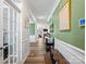 Long hallway with neutral paint, wood floors, and artwork on the walls at 4316 Falls Lake Sw Dr, Concord, NC 28025