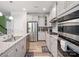 Modern kitchen features granite countertops, stainless steel appliances, and grey cabinets at 4316 Falls Lake Sw Dr, Concord, NC 28025