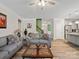 Open living room with wood floors and view into kitchen at 4316 Falls Lake Sw Dr, Concord, NC 28025