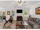 Bright living room features a cozy fireplace, ceiling fan, and wood floors at 4316 Falls Lake Sw Dr, Concord, NC 28025