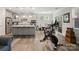 Open-concept living space featuring a kitchen island, dining area, and exercise equipment at 4316 Falls Lake Sw Dr, Concord, NC 28025