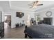 This main bedroom includes an ensuite bathroom, walk-in closet, and a ceiling fan at 4316 Falls Lake Sw Dr, Concord, NC 28025
