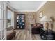 Comfortable office with dark bookshelf, leather chair, and natural light at 4316 Falls Lake Sw Dr, Concord, NC 28025