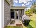 Relaxing screened patio features comfortable seating, ceiling fan, and outdoor grill at 4316 Falls Lake Sw Dr, Concord, NC 28025
