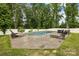 Private backyard pool with lounge chairs and surrounding greenery, perfect for relaxation and entertaining at 5384 Gatsby Cir, Rock Hill, SC 29732