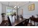 Dining room features coffered ceiling, modern chandelier, large window, and seating for six on hardwood floors at 5384 Gatsby Cir, Rock Hill, SC 29732