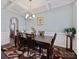 Elegant dining room with coffered ceiling, chandelier, and a dark wood table with seating for six at 5384 Gatsby Cir, Rock Hill, SC 29732
