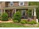 Charming brick home with covered front porch, manicured landscaping, and an American flag at 5384 Gatsby Cir, Rock Hill, SC 29732