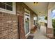 Charming front porch with brick columns, welcome sign, and inviting seating area at 5384 Gatsby Cir, Rock Hill, SC 29732