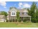 Charming two-story brick home with a well-manicured lawn and inviting front porch at 5384 Gatsby Cir, Rock Hill, SC 29732