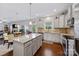 Bright eat-in kitchen boasts stainless steel appliances, granite counters, view to the living and dining area at 5384 Gatsby Cir, Rock Hill, SC 29732